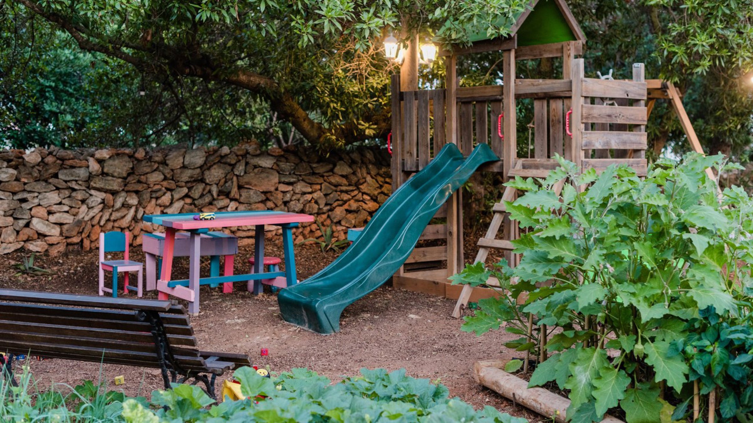 A Play Area For Kids With Slide And Playhouse