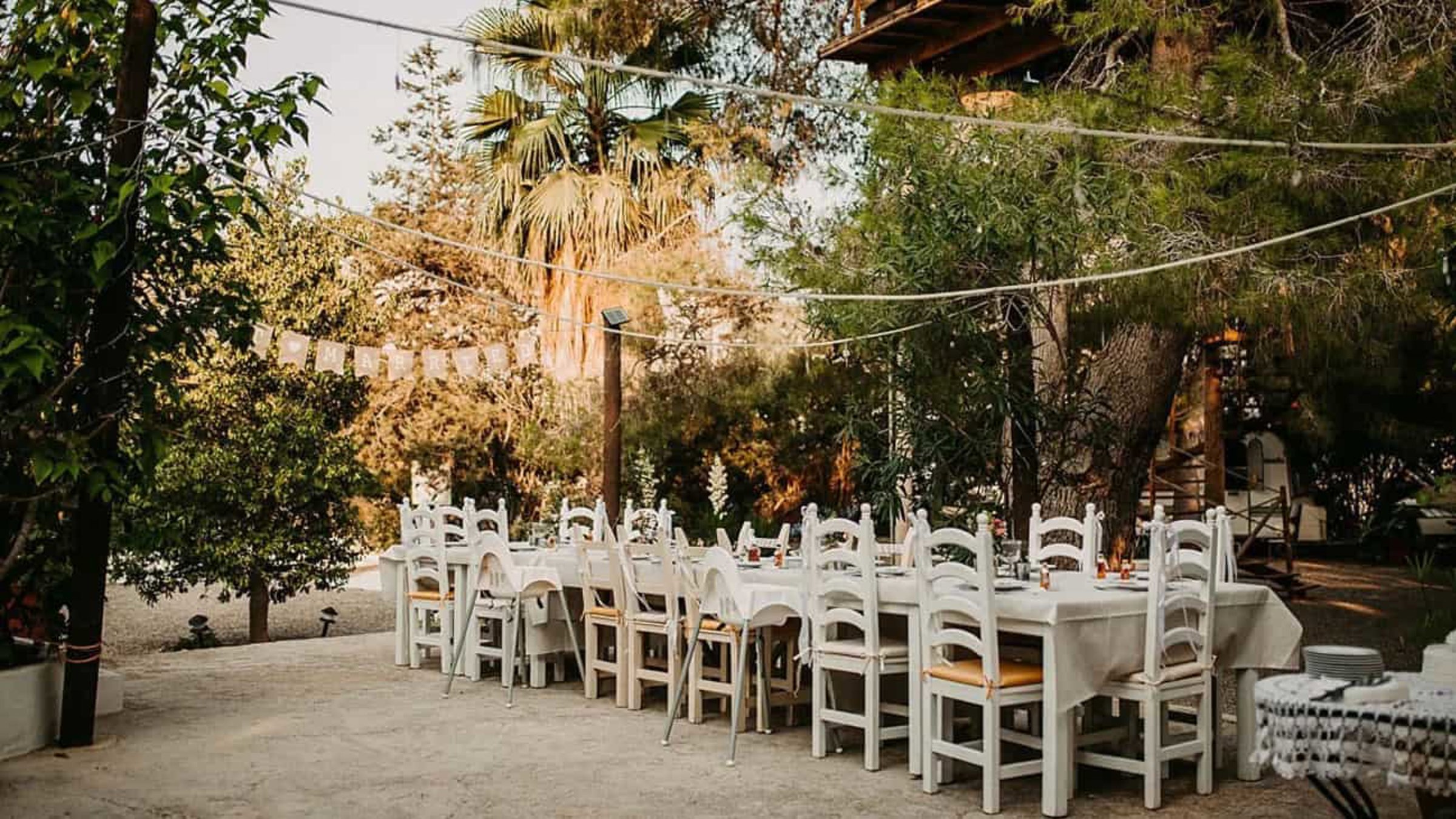 Table Setup With White Chairs For Wedding Event (1)