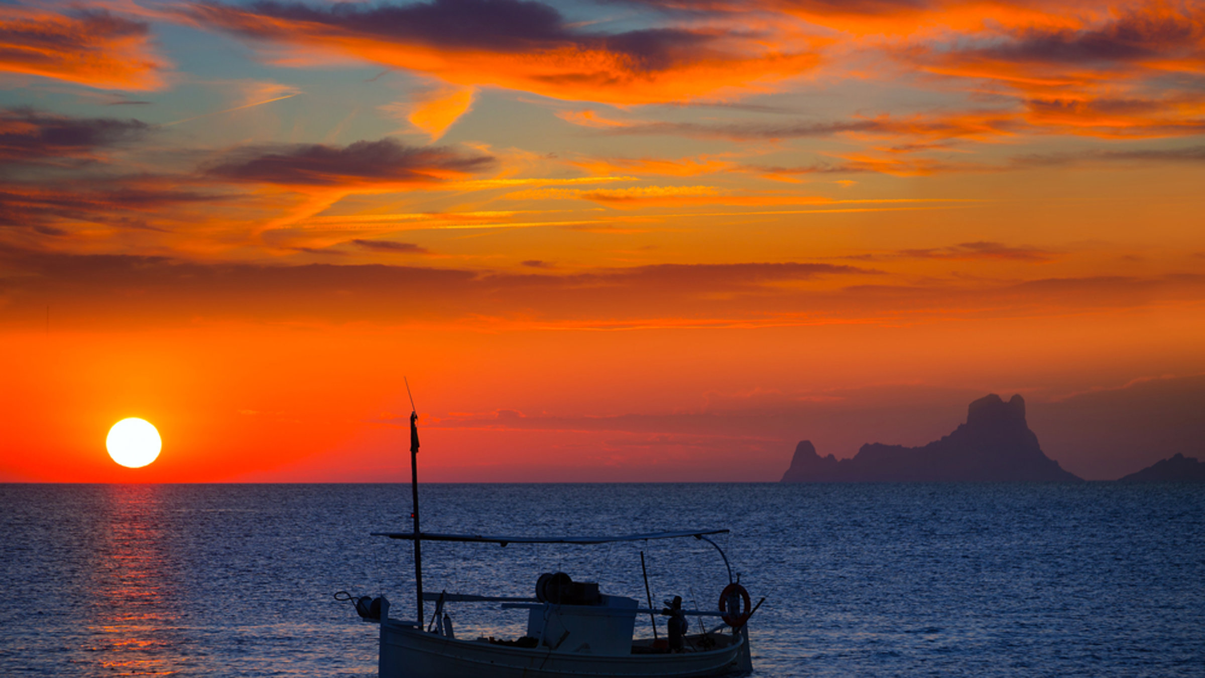 Orange sunset with boat on the sea