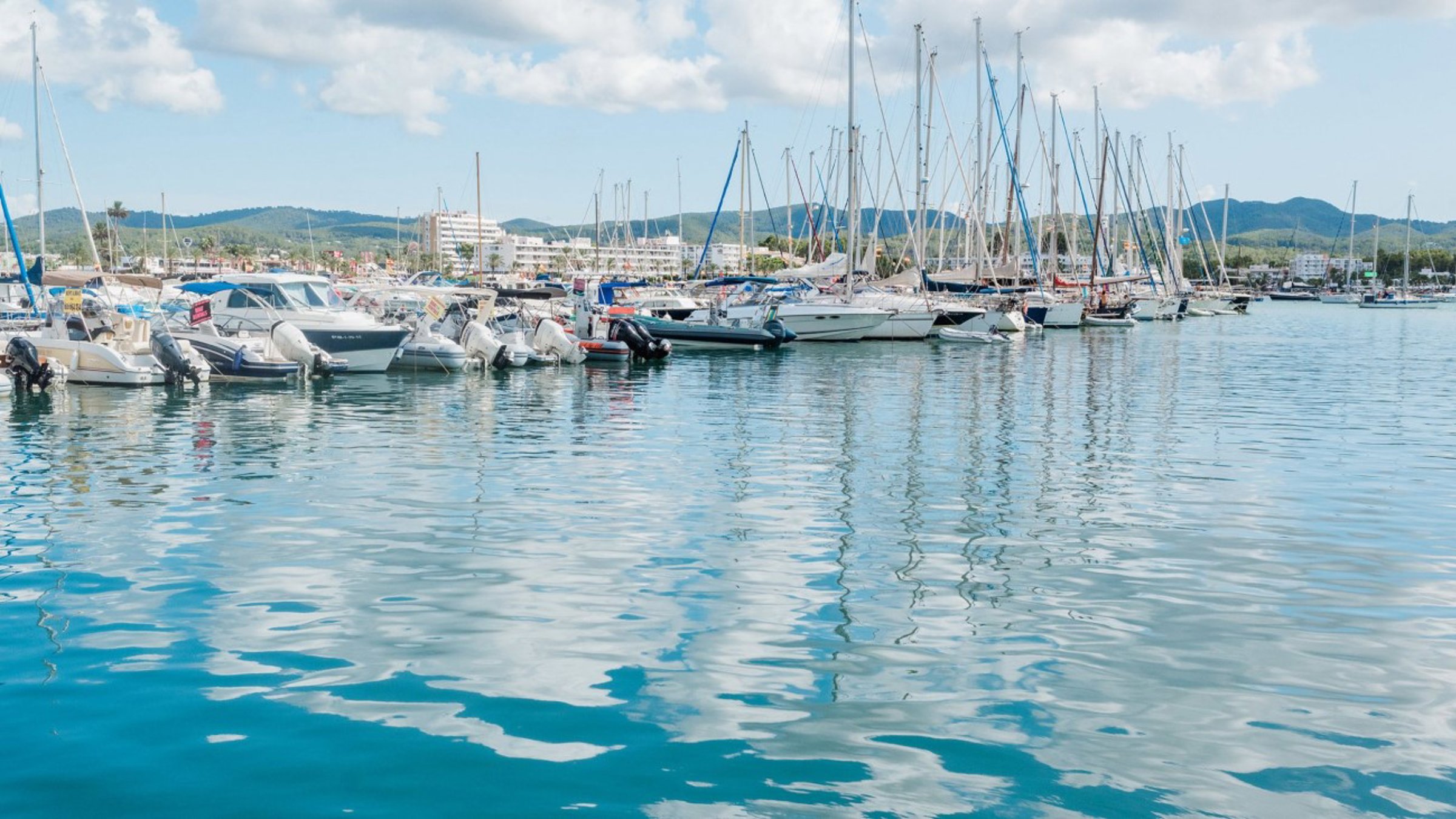 Boats In Port On Sunny Day With Random Clouds