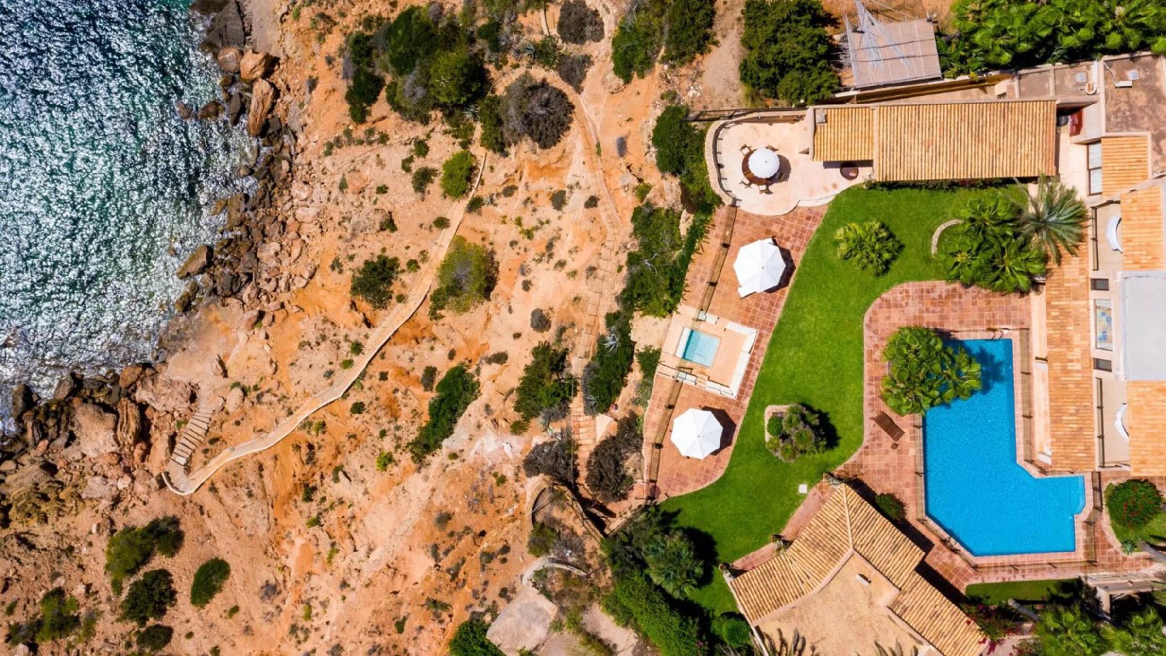Aerial View Of A Villa With Pool And Direct Sea Access