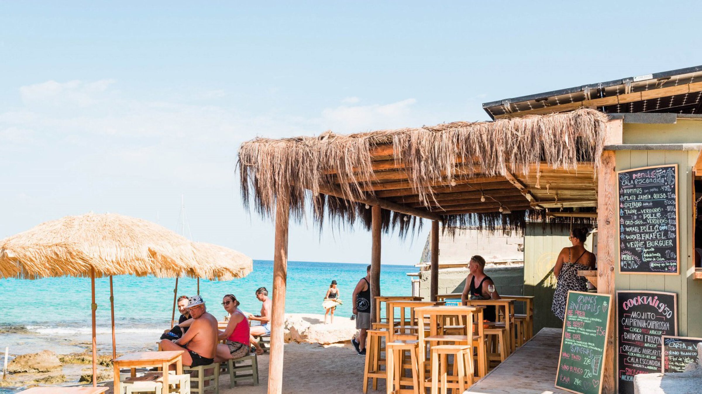 Terrace By The Beach With People Seating At The Table