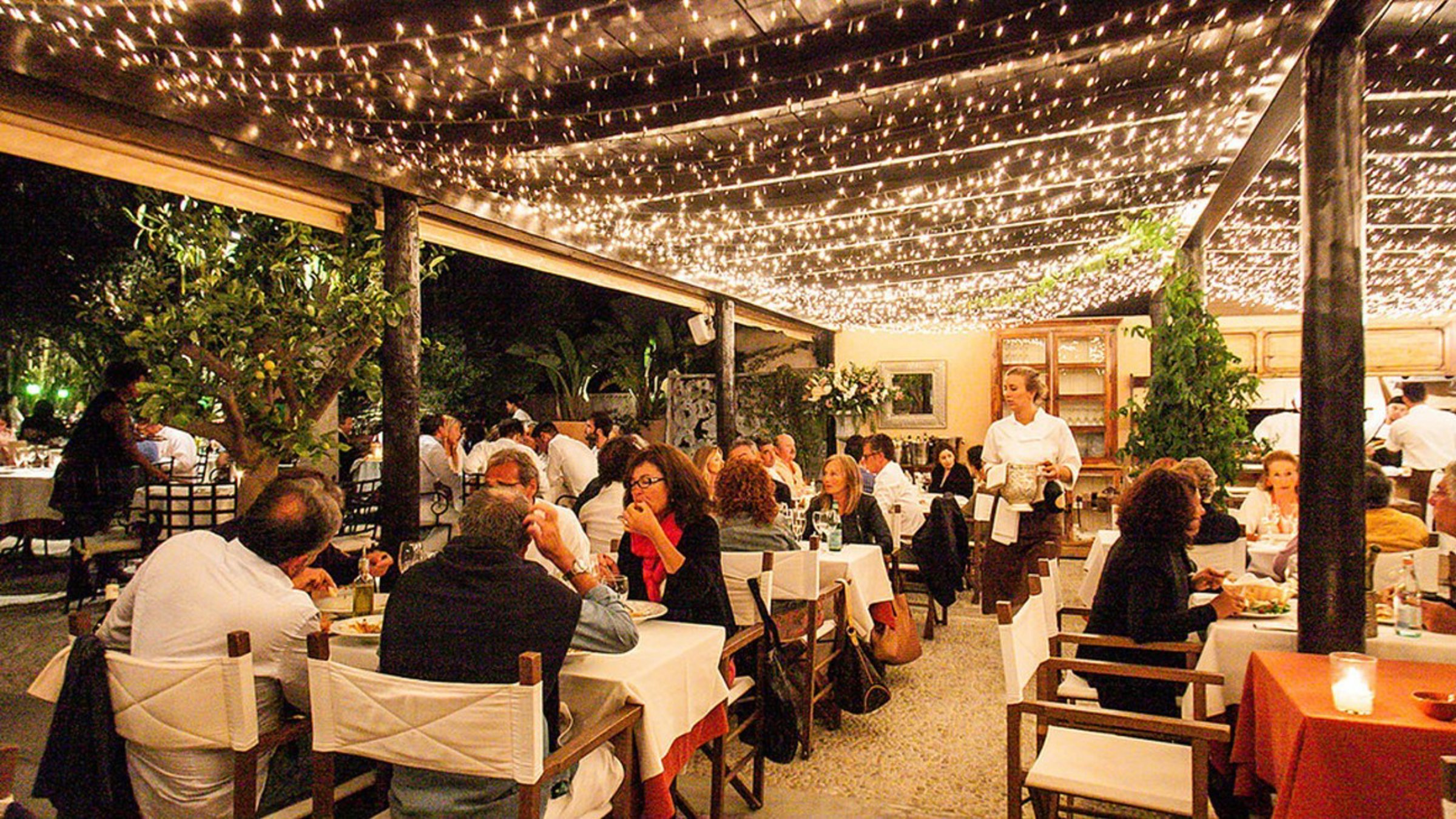 A Dinner With People Seatting At The Table In A Restaurant